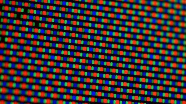 Magnified view of OLED display pixels, each containing one red, one blue, and two green subpixel elements.