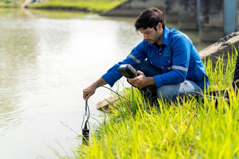 A technician use the Professional Water Testing equipment to measure the water quality at the public canal.
