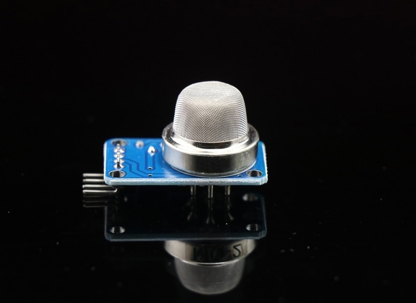 gas sensor for arduino projects isolated on reflective black glass background, MQ2 gas sensor for gas leakage sensing